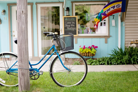 Old bicycle in front of small shop. Image by Jill Wellington from Pixabay